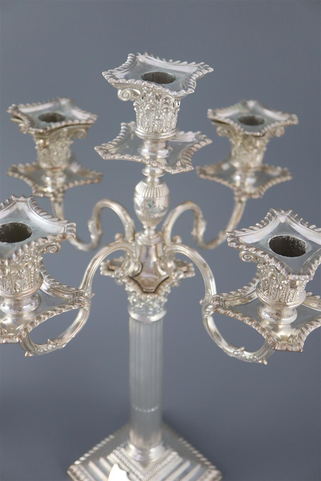 A pair of late Victorian silver corinthian column four branch, five light candelabra by Carrington & Co,